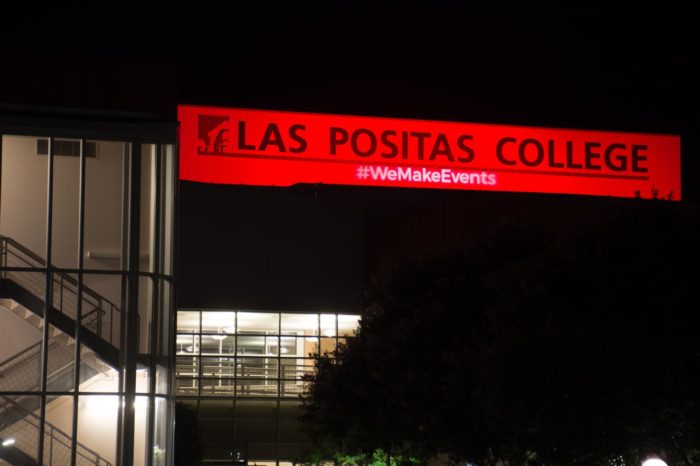 Mertes Center For The Arts lit in red to support artists